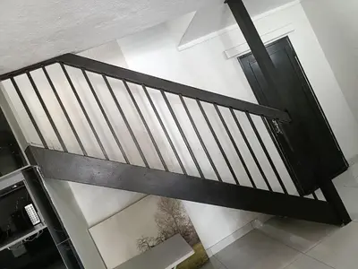 an overhead view of a black staircase with a door at Beautiful apartment behind Illanga Mall in Mataffin