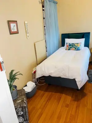 a bedroom with a bed and a wooden floor at Airbnb at Bailyes in Pretoria