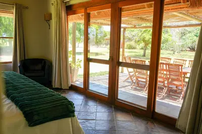 a room with a bed and a sliding glass door at Lucca House in Musina