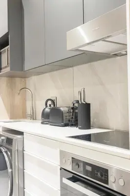 a kitchen with white cabinets and a stove top oven at The Trilogy Apartment MM 51011 in Pretoria