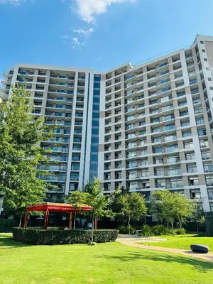 a large apartment building with a park in front of it at The Trilogy Apartment MM 51011 in Pretoria