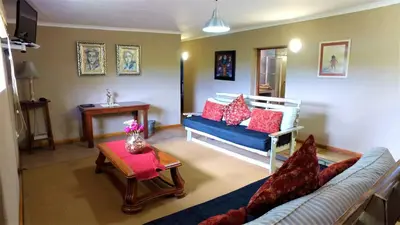 a living room with a couch and a table at Blyde Mountain Country House in Hoedspruit