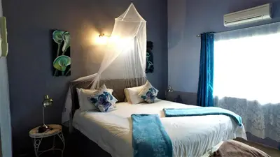a bedroom with a bed with a canopy at Blyde Mountain Country House in Hoedspruit