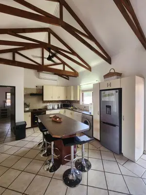 a kitchen with a table and chairs in it at Stella Bush Villa in Hoedspruit