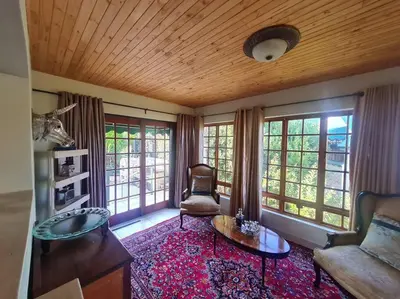 a living room with a couch and a table at Stonefields 3 Bedroom Charmer in Dullstroom