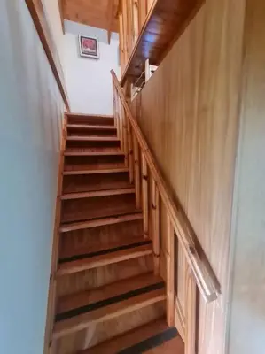 a staircase with wooden steps in a building at Stonefields 3 Bedroom Charmer in Dullstroom