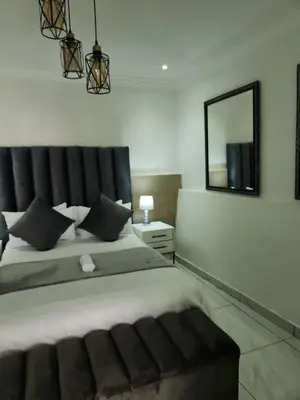 a bedroom with a large bed with a mirror on the wall at Le Bamboo Guest House And Boat Cruise in Hartbeespoort