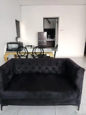 a black leather couch in a living room at Le Bamboo Guest House And Boat Cruise in Hartbeespoort