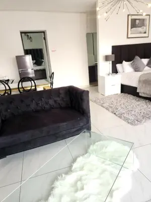 a living room with a couch and a glass table at Le Bamboo Guest House And Boat Cruise in Hartbeespoort
