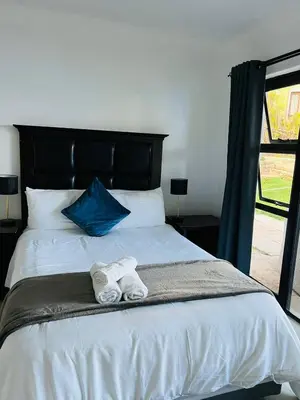 a bedroom with two towels on a bed at Le Bamboo Guest House And Boat Cruise in Hartbeespoort