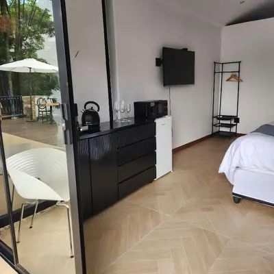 a room with a bed and a television and a bedroom at Le Bamboo Guest House And Boat Cruise in Hartbeespoort