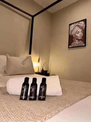 three bottles of wine sitting on top of a bed at SUumthing Private GuestHouse in Lebowakgomo