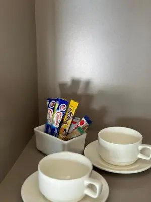 a table with two white plates and two cups at SUumthing Private GuestHouse in Lebowakgomo