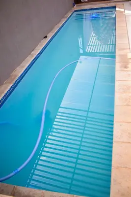 an empty swimming pool with blue water at De Guest @115 in Centurion