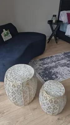 two round stools in a living room with a couch at Ellipse Apartment, Lush Hideaway in Midrand