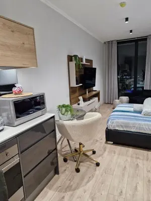 a room with a bed and a desk with a chair at Ellipse Apartment, Lush Hideaway in Midrand