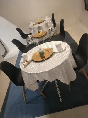 a white table with black chairs and a table with plates at Serene B&B in Midrand
