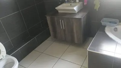 a bathroom with a sink and a toilet at Serene B&B in Midrand