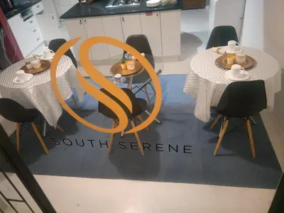 a table with two chairs and a table with a orb at Serene B&B in Midrand