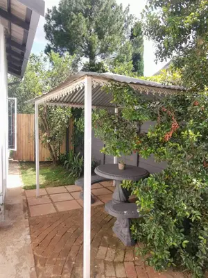 a pergola with a planter in a garden at Stay@Opstal in Pretoria