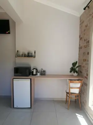 a kitchen with a counter and a chair at Stay@Opstal in Pretoria
