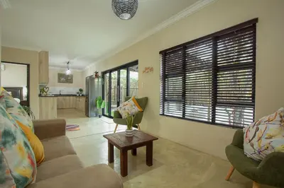 a living room with a couch and a table at EDJAMI Guest House in Marloth Park