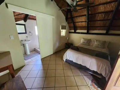 a bedroom with a bed and a sink in a room at Lama Lama Game Reserve in Mount Hope