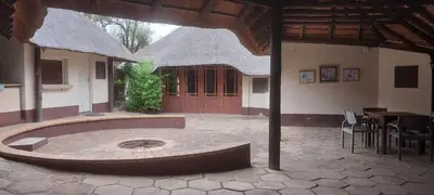 a building with a circle in the middle of a courtyard at Lama Lama Game Reserve in Mount Hope