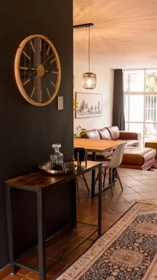 a living room with a large clock on the wall at Grace in Pretoria