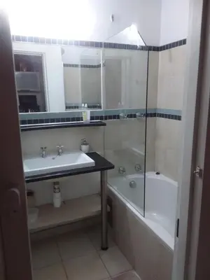 a bathroom with a sink and a tub and a toilet at Charming apartment in Pretoria