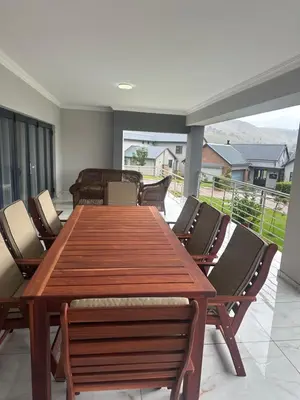 a wooden table and chairs in a room at 955 Highlands Gate Golf Estate in Dullstroom