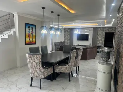 a dining room with a black table and chairs at 955 Highlands Gate Golf Estate in Dullstroom