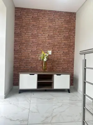 a brick wall with a vase of flowers on a table at 955 Highlands Gate Golf Estate in Dullstroom