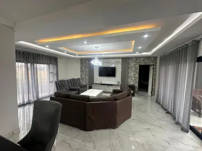 a living room with a couch and a tv at 955 Highlands Gate Golf Estate in Dullstroom