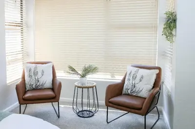 two chairs and a table in front of a window at Kirrin Cottage in Benoni in Benoni