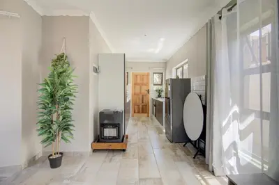 a hallway with a potted plant in a house at Kirrin Cottage in Benoni in Benoni