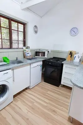a kitchen with a sink and a stove top oven at Lala Lapa Self Catering Accomodation in Nelspruit