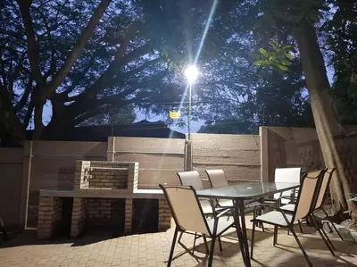 a table and chairs in a patio with a light at Lala Lapa Self Catering Accomodation in Nelspruit