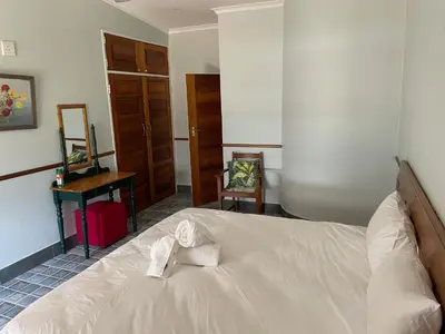 a bedroom with a bed with towels on it at Eagles View Kungwini in Erasmus
