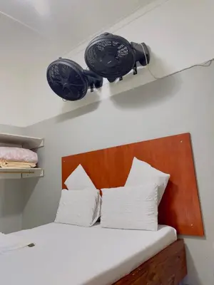 a bedroom with a bed with a light above it at Sunrise Guest Inn in Pretoria