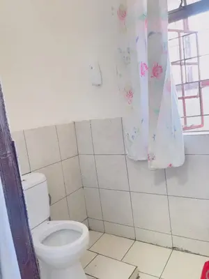 a bathroom with a toilet and a window at Sunrise Guest Inn in Pretoria