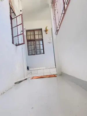 an empty room with a door and a window at Sunrise Guest Inn in Pretoria