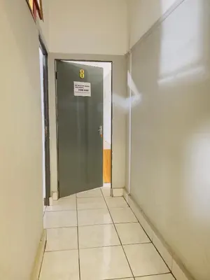 a hallway with a door with the number eight on it at Sunrise Guest Inn in Pretoria