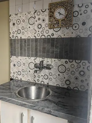 a bathroom sink with a clock on the wall at Choosers Express Boutique Hotel and Spa - Room 2 in Centurion