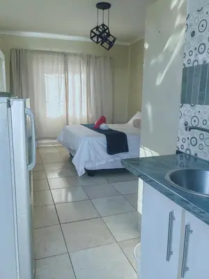 a kitchen with a bedroom with a bed in it at Choosers Express Boutique Hotel and Spa - Room 2 in Centurion