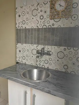 a bathroom sink with a clock on the wall at Choosers Express Boutique Hotel and Spa - Room 2 in Centurion