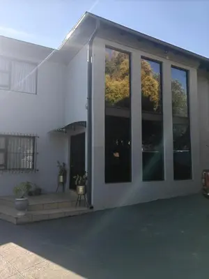a white house with large glass windows on it at Choosers Express Boutique Hotel and Spa - Room 2 in Centurion