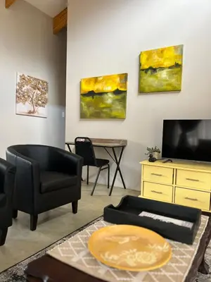 a living room with a couch and a tv and a table at The Bird House in Kampersrus AH