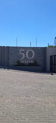 a sign on the side of a brick wall at The Ace apartment @50 on lever(with backup power) in Midrand