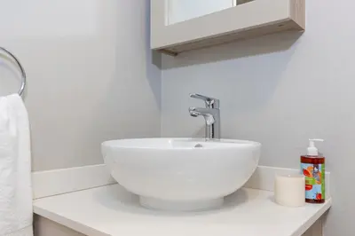 a bathroom with a white sink on a counter at The Ace apartment @50 on lever(with backup power) in Midrand